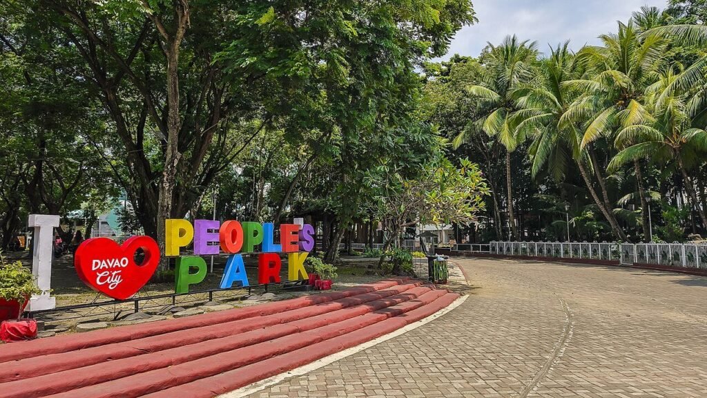 Colourful People's Park sign beside a tree-lined walkway at People's Park in Davao City, Philippines.