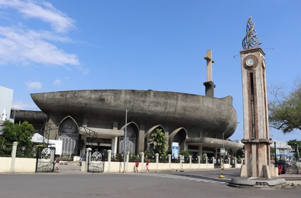 San Pedro Cathedral in Davao City, featuring its distinctive curved concrete roof and neighbouring clock tower.
